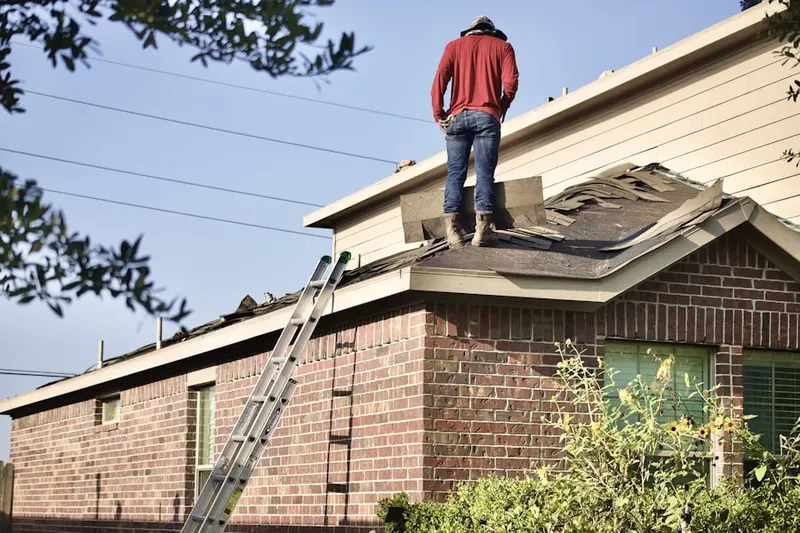 Professional roofer working on a residential roof in Downtown Decatur